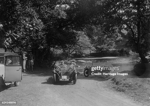 Singer Le Mans and MG D type at the Mid Surrey AC Barnstaple Trial, Tarr Steps, Exmoor, 1934. Artist: Bill Brunell.Centre: Singer Le Mans. 1933 972...