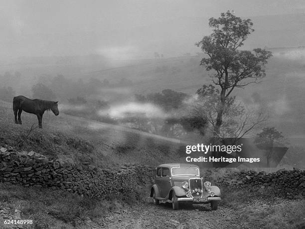 Ford V8 saloon of RE Alexander competing in the MCC Sporting Trial, 1935. Artist: Bill Brunell.Ford V8 Saloon 1934 3622 cc. Vehicle Reg. No. WG2882....