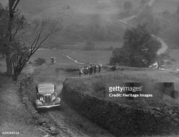 Ford V8 saloon of F Allott competing in the MCC Sporting Trial, 1935. Artist: Bill Brunell.Ford V8 Saloon 1934 3622 cc. Vehicle Reg. No. BHX342....