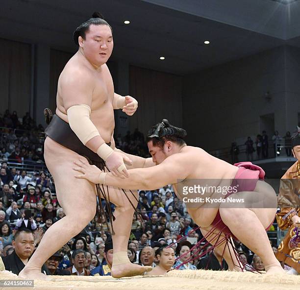 Grand champion Hakuho is bundled out of the ring by third-ranked maegashira Endo on the sixth day of the Kyushu Grand Sumo Tournament at Fukuoka...