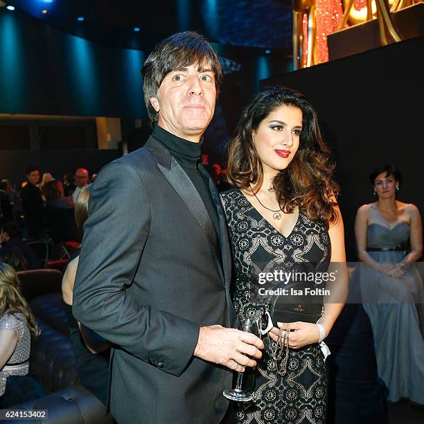 German soccer trainer Joachim Loew and Miss Bambi Rumi Akaber pose at the Bambi Awards 2016 party at Atrium Tower on November 17, 2016 in Berlin,...