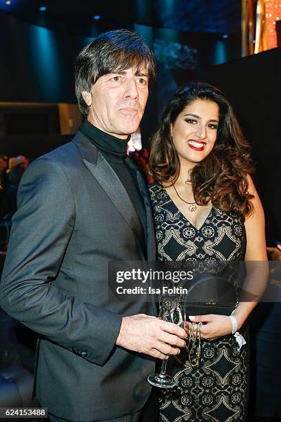 German soccer trainer Joachim Loew and Miss Bambi Rumi Akaber pose at the Bambi Awards 2016 party at Atrium Tower on November 17, 2016 in Berlin,...