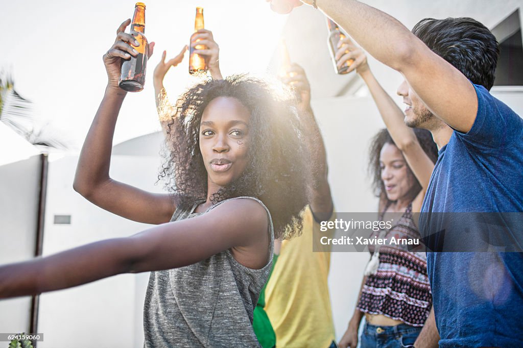 Young friends dancing at rooftop party