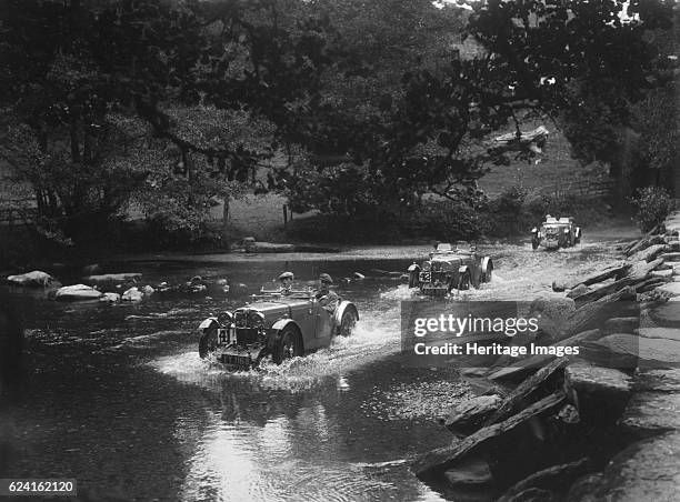 J2s of Kennneth and Doreen Evans, Mid Surrey AC Barnstaple Trial, Tarr Steps, Exmoor, 1934. Artist: Bill Brunell.MG J2 1932 847 cc. Reg. No. YY1168....