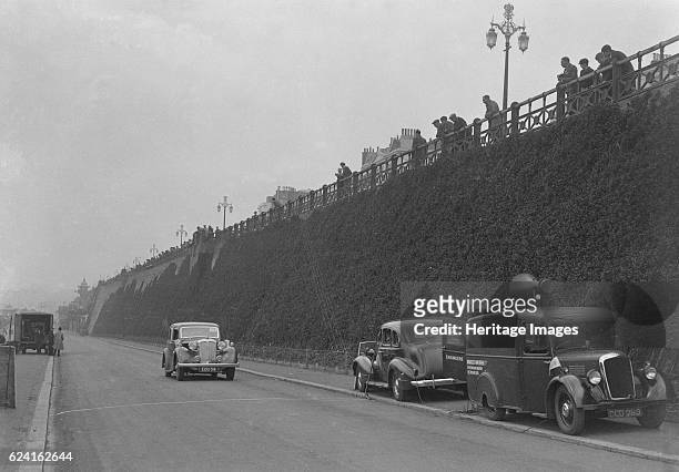 Daimler of CM Simpson and a Morris loudspeaker van on Madeira Drive, Brighton, RAC Rally, 1939. Artist: Bill Brunell.Daimler 24 h.p. Vehicle Reg. No....