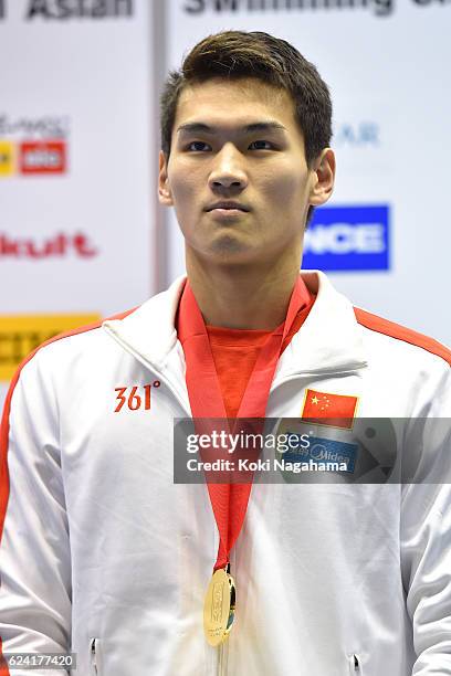 Gold medalist Xu Jiayu of China stands for his national anthem after Men's 200m Backstoke final race during the 10th Asian Swimming Championships...