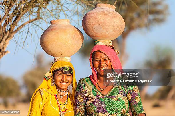 indian women carrying water, rajasthan - village stock pictures, royalty-free photos & images
