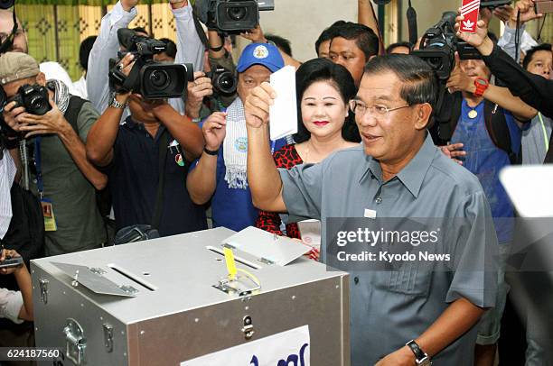 Cambodia - Cambodian Prime Minister Hun Sen votes in the country's general election at a polling station in Kandal province on July 28 watched by his...