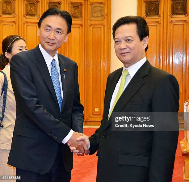 Vietnam - Keiji Furuya , Japan's state minister in charge of the issue of North Korea's abductions of Japanese nationals, shakes hands with...