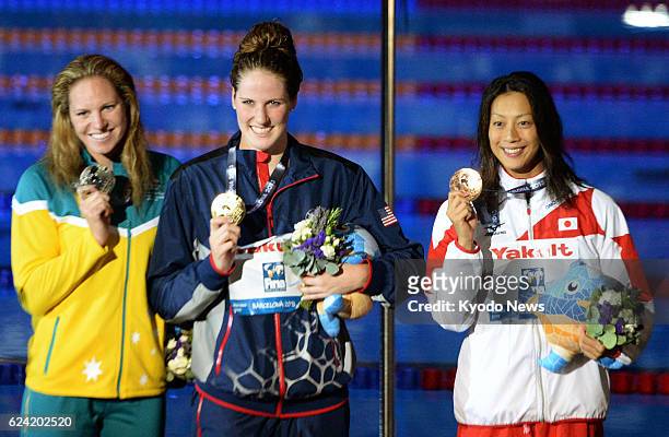 Spain - American Missy Franklin , Emily Seebohm of Australia and Aya Terakawa of Japan show their gold, silver and bronze medals, respectively, in...