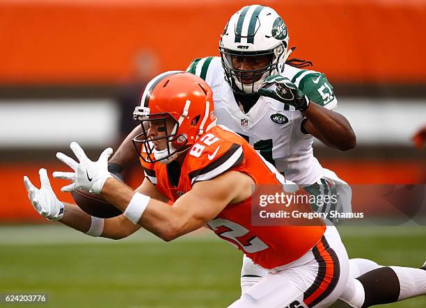 Gary Barnidge of the Cleveland Browns makes a catch in front of Julian Stanford of the New York Jets during the first quarter at FirstEnergy Stadium...