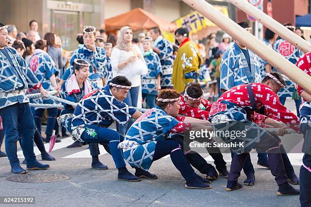 pulling rope together to move parade float - saba sushi stock pictures, royalty-free photos & images