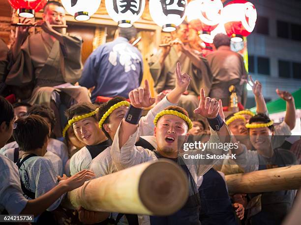 matsuri guys pushing huge parade float by their back - saba sushi stock pictures, royalty-free photos & images