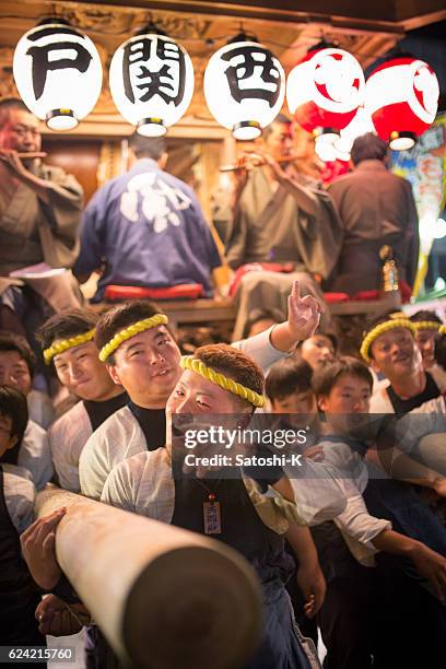 matsuri guys pushing huge parade float by their back - saba sushi stock pictures, royalty-free photos & images