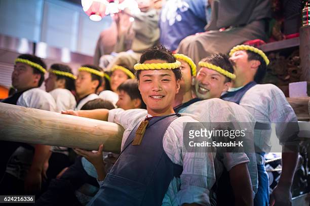 sweet boy pushing parade float in sawara autumn festival - saba sushi stock pictures, royalty-free photos & images