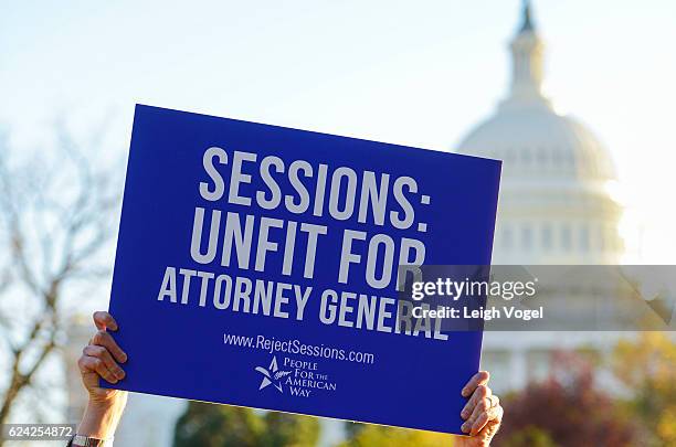 Drew Courtney, Director of Communications for People for the American Way holds a sign to call on senate to reject Jeff Sessions as Attorney General...