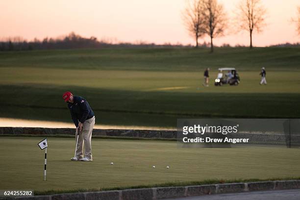 Man practices on the putting green prior to the arrival of president-elect Donald Trump's motorcade at Trump National Golf Club, where...