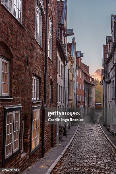 narrow alley in luebeck - lübeck stock pictures, royalty-free photos & images
