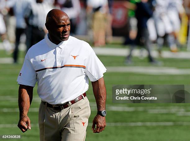 Head coach Charlie Strong of the Texas Longhorns watches as his team warms-up before the game against the West Virginia Mountaineers at Darrell K...