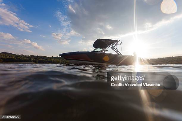 wakeboard boat view from the water. - wakeboarden stock-fotos und bilder