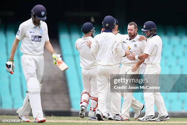 John Holland of the Bushrangers celebrates with team mates after dismissing Kurtis Patterson of the Blues during day three of the Sheffield Shield...