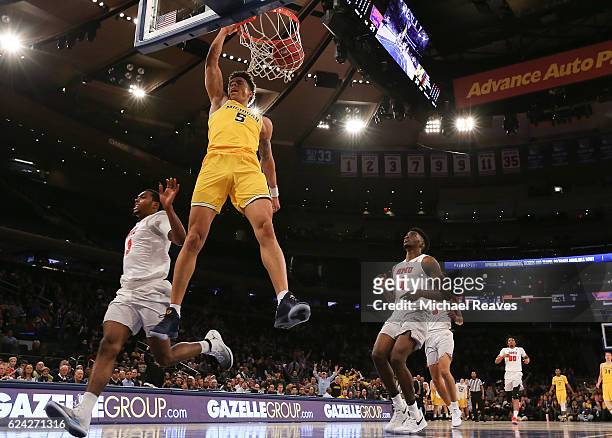 Wilson of the Michigan Wolverines celebrates after a dunk against the Southern Methodist Mustangs in the first half of the 2K Classic Championship at...
