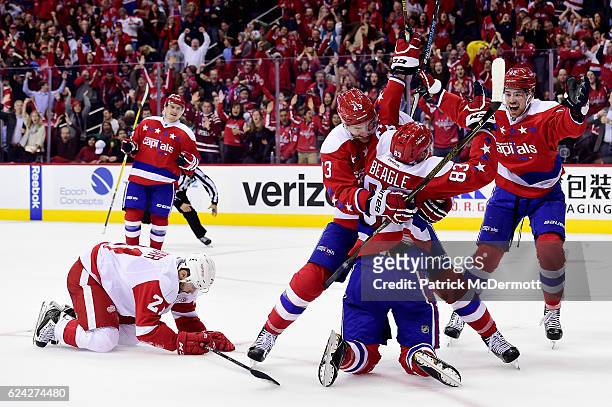 Jay Beagle of the Washington Capitals celebrates his third period goal with teammate Tom Wilson during a NHL game against the Detroit Red Wings at...