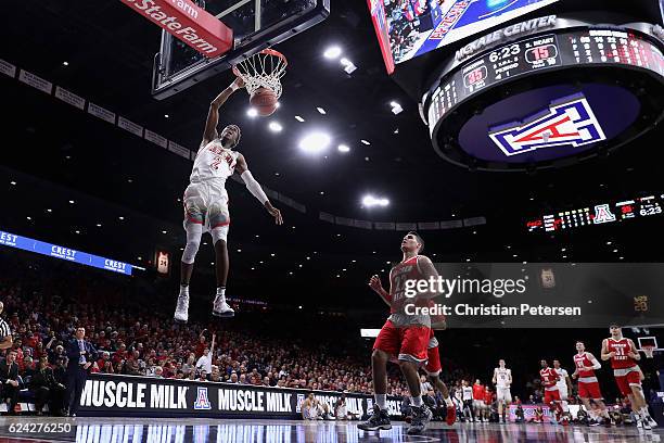 Kobi Simmons of the Arizona Wildcats slam dunks the ball ahead of Sean Hoehn of the Sacred Heart Pioneers during the first half of the college...