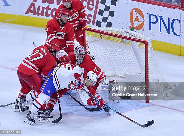 Max Pacioretty of the Montreal Canadiens works to score against Justin Faulk, Teuvo Teravainen and Cam Ward of the Carolina Hurricanes during the...