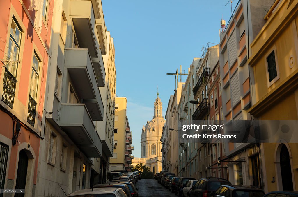 Street of lisbon in the neighborhood with Basilica da Estrela in the background