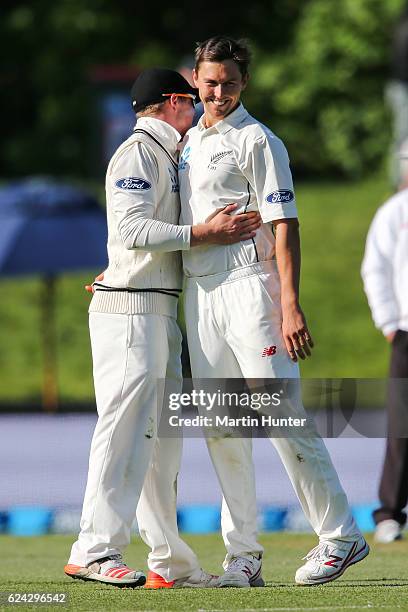 Trent Boult of New Zealand is congratulated by Henry Nicholls after bowling Sarfaraz Ahmed of Pakistan during day three of the First Test between New...