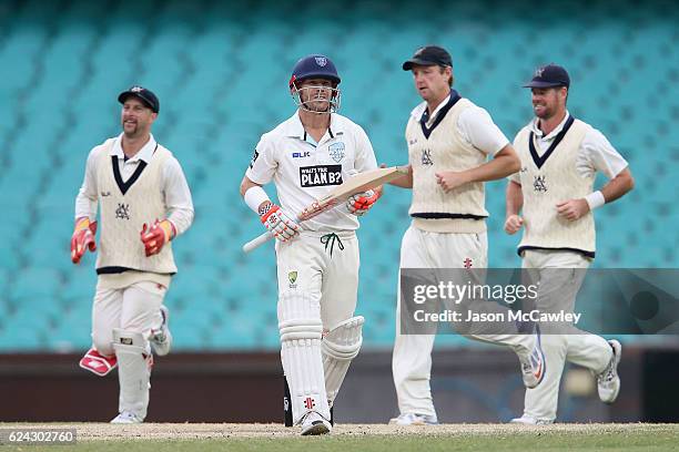 David Warner of the Blues walks back to the pavilion after being dismissed by Chris Tremain of the Bushrangers during day three of the Sheffield...