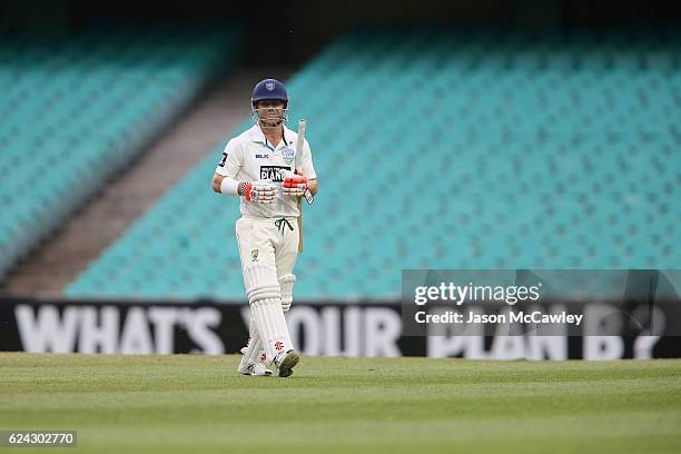 David Warner of the Blues walks back to the pavilion after being dismissed by Chris Tremain of the Bushrangers during day three of the Sheffield...