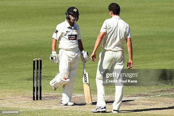 Jonathan Wells of Western Australia shows Simon Milenko of Tasmania the ball wedged in his pad during day three of the Sheffield Shield match between...