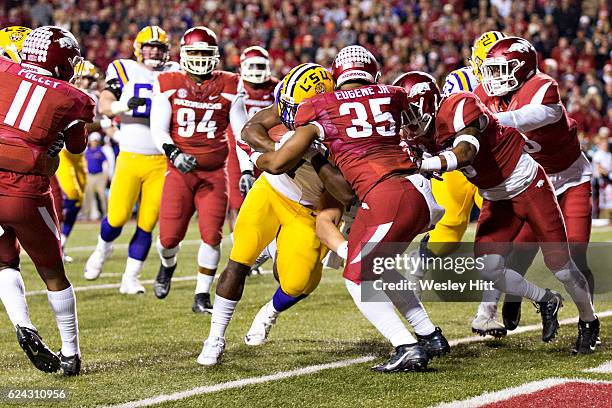 Leonard Fournette of the LSU Tigers pushes his way into the end zone for a touchdown against Dwayne Eugene of the Arkansas Razorbacks at Razorback...