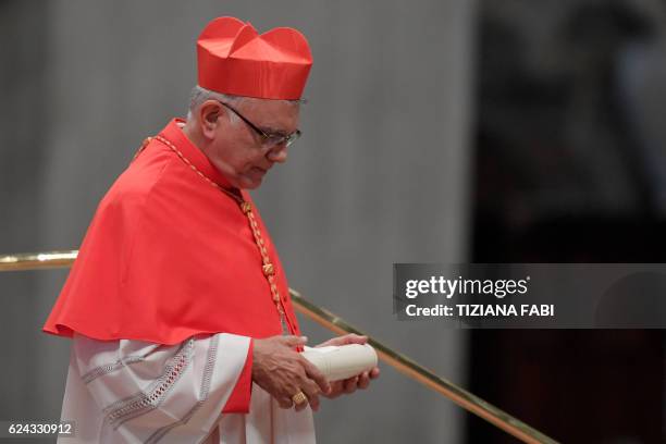 Archbishop of Merida in Venezuela, Baltazar Enrique Porras Cardozo, walks after kneeling before Pope Francis to pledge allegiance and become...