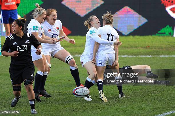 Fiona Pocock of England is congratulated by teammates after scoring the opening try during the Old Mutual Wealth Series Women's match between England...