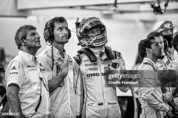 In this handout image provided by Red Bull, Porsche Vice President LMP1, Fritz Enzinger of Austria, Porsche LMP1 car drivers Mark Webber of...