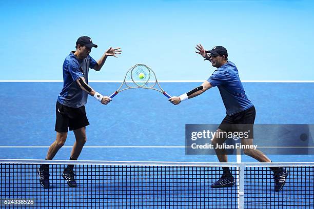 Mike Bryan of the United States and Bob Bryan of the United States attempt to volley at the net during their men's doubles semi-final match against...