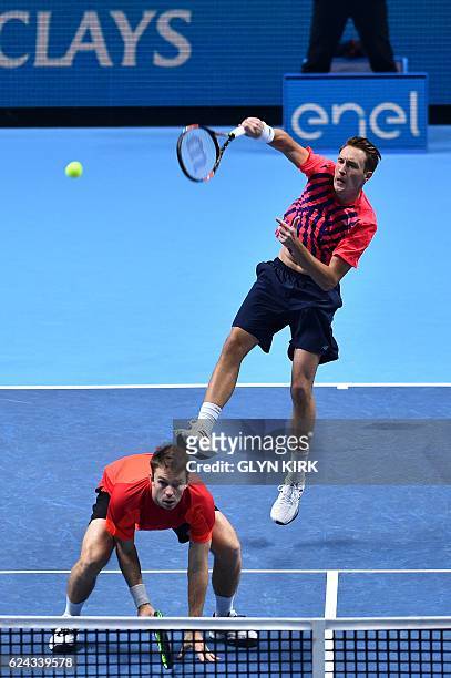 Finland's Henri Kontinen returns over the head of his partner Australia's John Peers against US player Bob Bryan and US player Mike Bryan during...