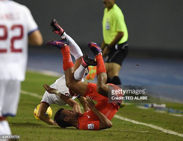 Singapore football player Shakir Hamzah collides with Misagh Bahadoran of the Philippines during their Suzuki Cup football final round match at the...