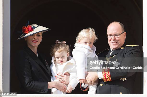 Princess Charlene of Monaco and Prince Albert II of Monaco greet the crowd from the palace's balcony with their children Princess Gabriella of Monaco...