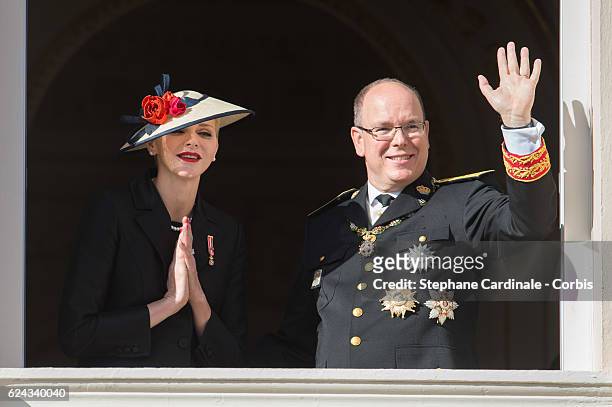 Princess Charlene of Monaco and Prince Albert II of Monaco greet the crowd from the palace's balcony during the Monaco National Day Celebrations on...