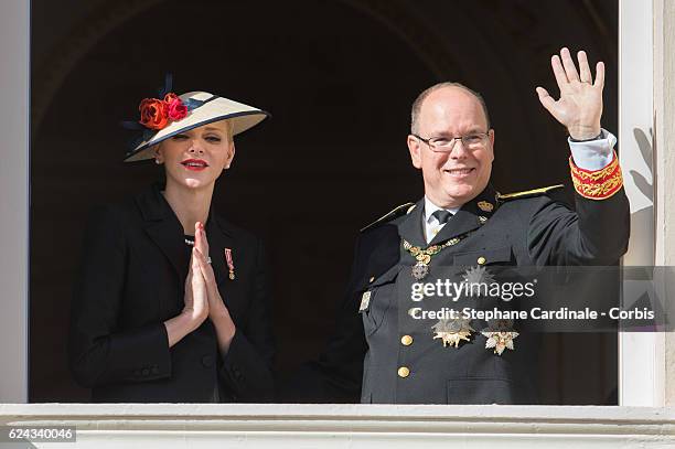 Princess Charlene of Monaco and Prince Albert II of Monaco greet the crowd from the palace's balcony during the Monaco National Day Celebrations on...