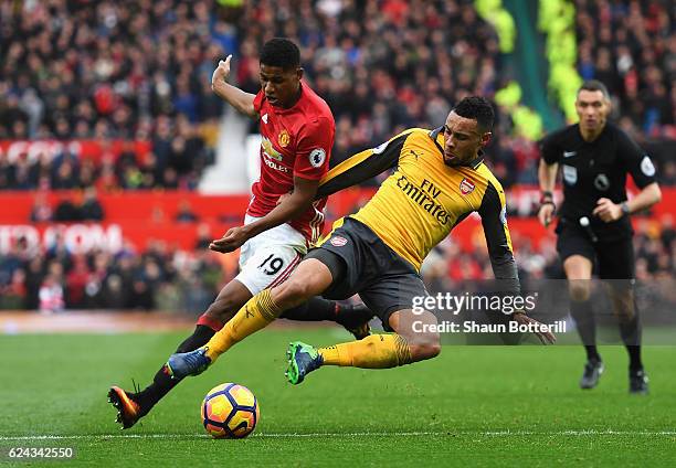 Marcus Rashford of Manchester United is tackled by Francis Coquelin of Arsenal during the Premier League match between Manchester United and Arsenal...