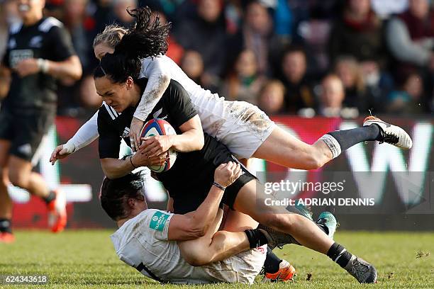 New Zealand's centre Portia Woodman is tackled by England's full-back Danielle Waterman and England's flanker Marlie Packer during the Old Mutual...