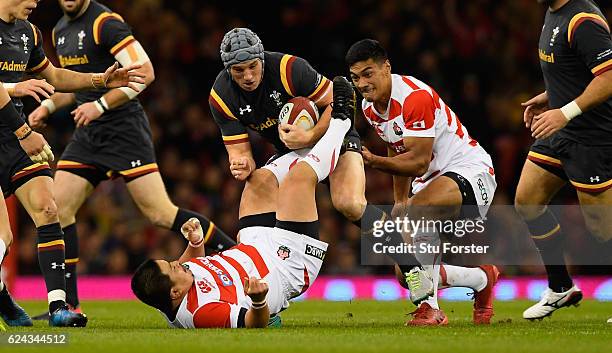 Japan player Satoshi Nakatani is knocked over by Jonathan Davies during the International match between Wales and Japan at Principality Stadium on...