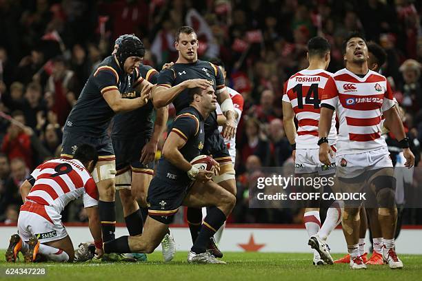 Wales' centre Jamie Roberts is congratulated by Wales' captain and flanker Sam Warburton after scoring their second try during the rugby union test...