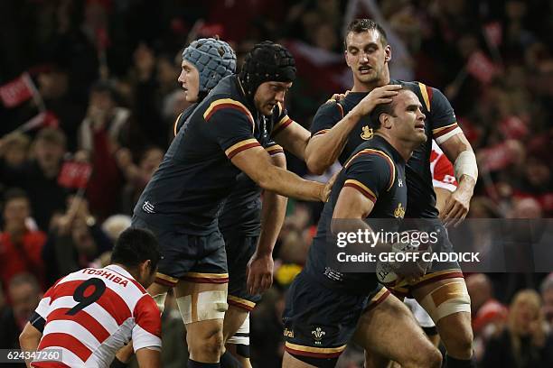 Wales' centre Jamie Roberts is congratulated by Wales' captain and flanker Sam Warburton after scoring their second try during the rugby union test...