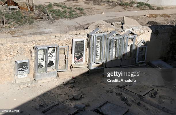 Graves of Christians damaged by Daesh terrorists are seen in the Behzan neighborhood of Bashiqa town, which was cleared from Daesh terrorists in an...